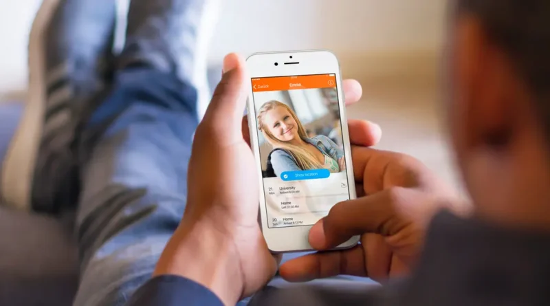 man holding cell phone, tracking someone in the family.