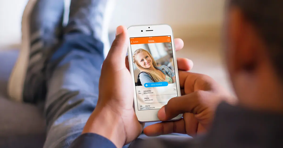 man holding cell phone, tracking someone in the family.